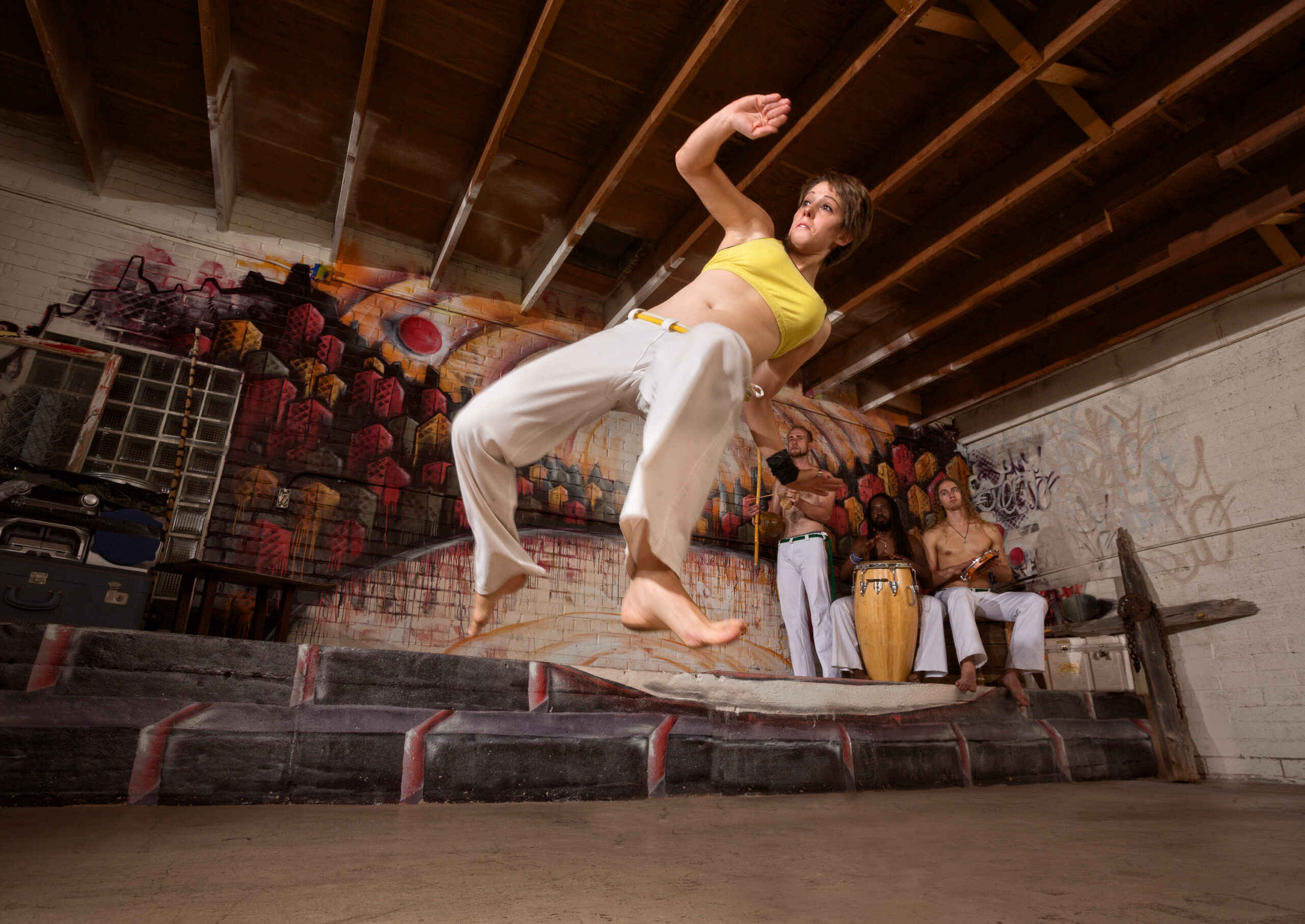 Woman showing capoeira flexibility during a Tucson Capoeira performance